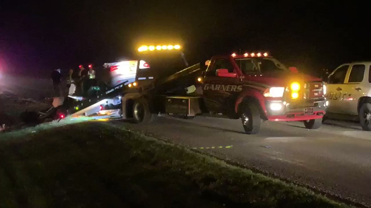 This Ford Focus that had four people inside of it is being put on a flat bed truck.  