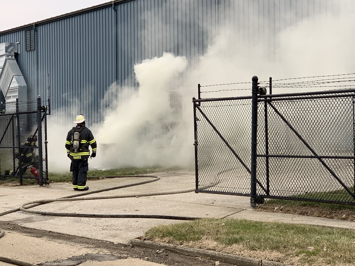 Firefighters use handline to cool outside of barrel containing epoxy as Haz Mat crews work with Major Tool personnel to mitigate chemical reaction.  12 students from nearby Zion Church preschool being relocated to IMPD site at 42nd & College.  No injuries