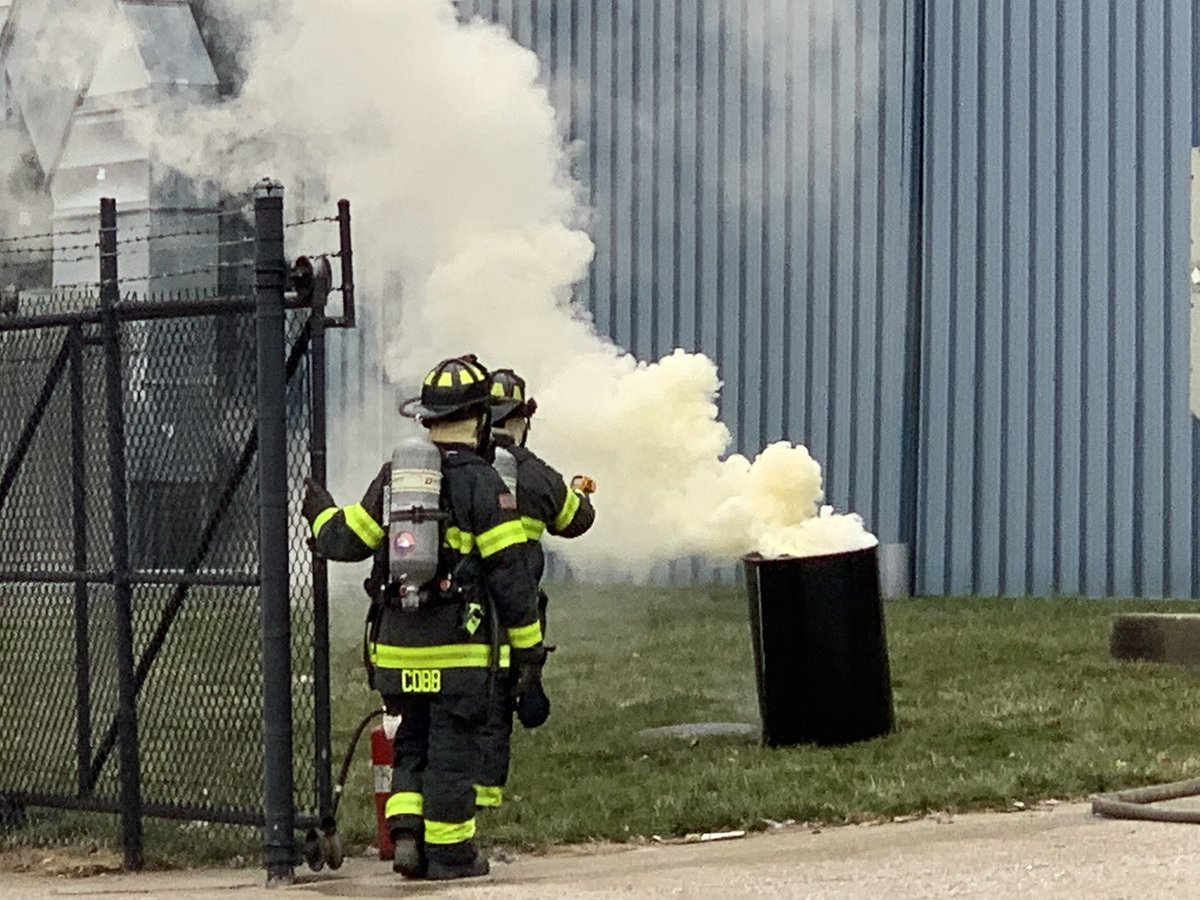 Firefighters use handline to cool outside of barrel containing epoxy as Haz Mat crews work with Major Tool personnel to mitigate chemical reaction.  12 students from nearby Zion Church preschool being relocated to IMPD site at 42nd & College.  No injuries